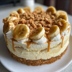 Cookie Butter Banana Pudding Cheesecake Cake with layers and toppings