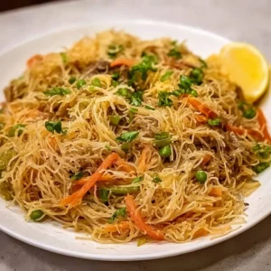 Delicious Filipino Pancit served in a bowl with vegetables and shrimp.
