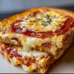 Melted cheese and pizza toppings in a grilled cheese sandwich