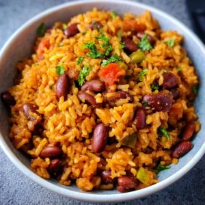 Delicious plate of Spanish Rice and Beans garnished with fresh herbs.