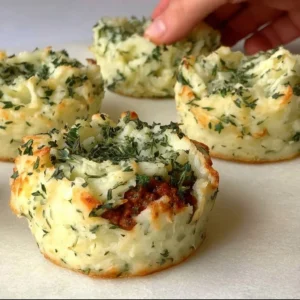 Stuffed mashed potato nests filled with cheese and herbs garnished on a plate