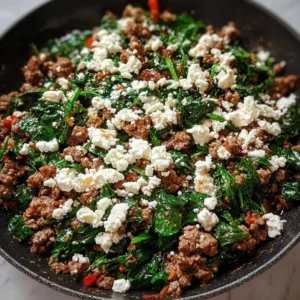 Ground beef and spinach skillet topped with feta cheese, a healthy dinner recipe.
