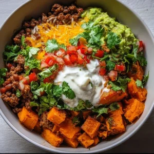 Vibrant sweet potato taco bowl topped with fresh ingredients and spices.