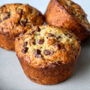 Freshly baked Banana Chocolate Chip Muffins cooling on a wire rack