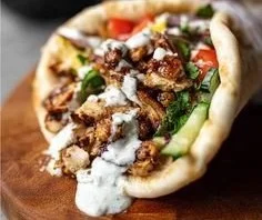 Delicious Chicken Shawarma served with creamy garlic sauce and fresh vegetables