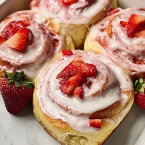 Delicious fluffy strawberry cinnamon rolls topped with icing