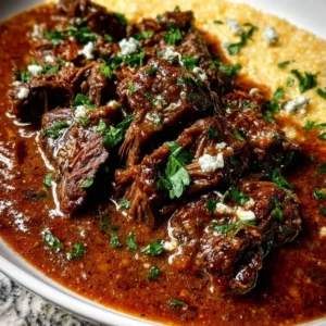 Delicious Italian Pot Roast with oven-baked Gorgonzola polenta on a rustic table.