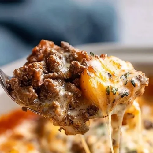 Crockpot beef potato dish with ground beef and diced potatoes in a rich sauce.