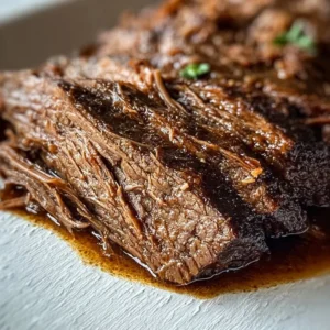 Delicious slow-cooked beef brisket with seasonings, served on a cutting board.